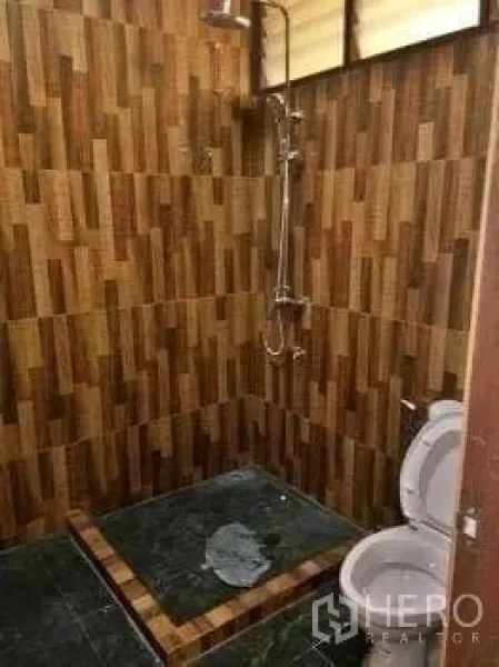 Office Space for rent in Chatuchak, Bangkok - Office bathroom with tiled shower area, patterned wall tiles and a toilet.
