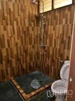 Office Space for rent in Chatuchak, Bangkok - Office bathroom with tiled shower area, patterned wall tiles and a toilet.
