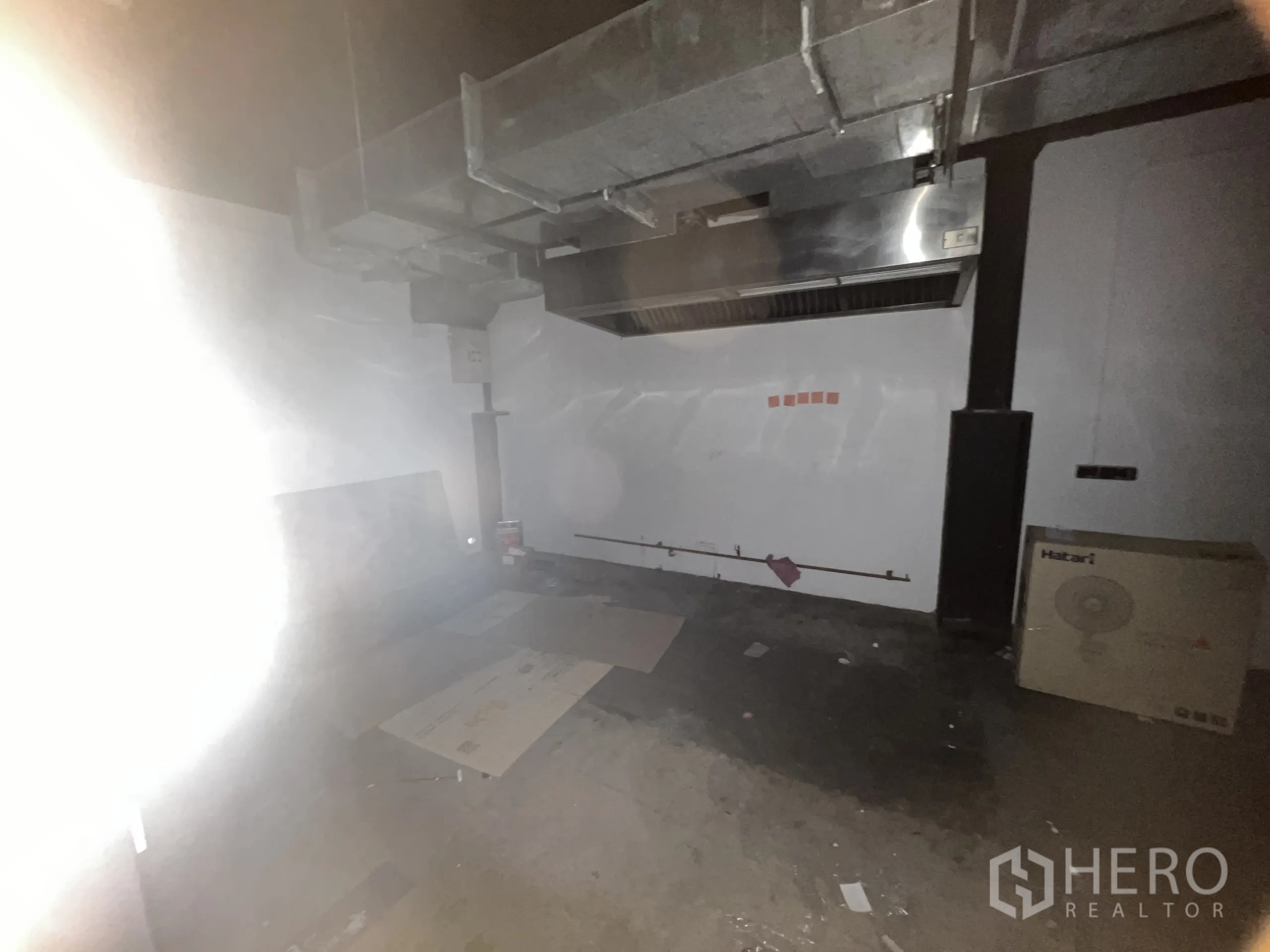 Retail Space for rent in Watthana, Bangkok - Empty kitchen space with extraction hood and exposed ducting.