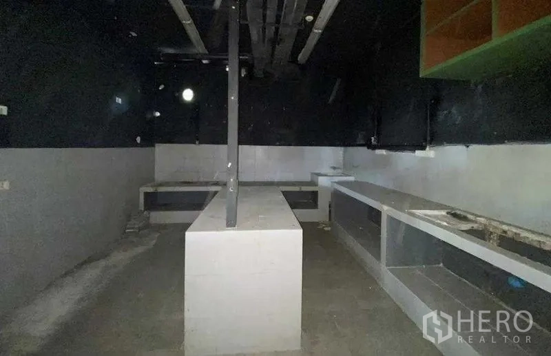 Retail Space for rent in Khlong Toei, Bangkok - Back-of-house prep room with built-in countertops and exposed services.