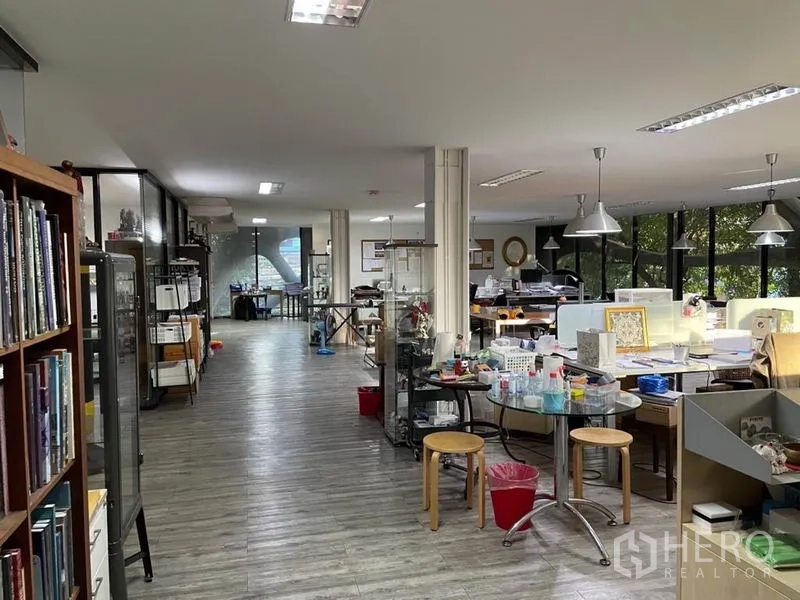 Office Space for rent in Khlong Toei, Bangkok - Open-plan office floor with workstations, shelving and pendant lights.