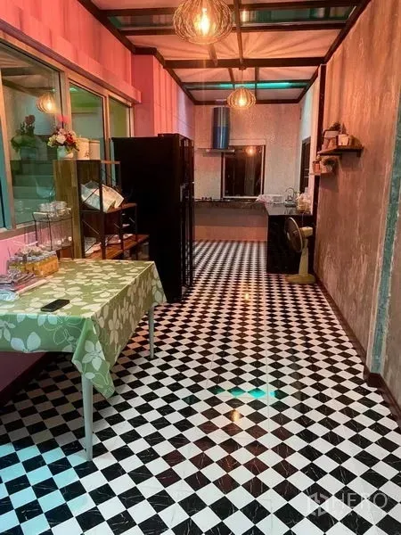 Warehouse for rent in Thanyaburi, Pathum Thani - Pantry with black-and-white checkerboard tiles, shelving, pendant lights and windowed wall to the kitchen.