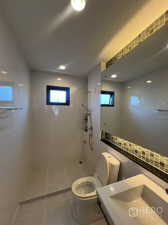 Detached House for rent in Bang Kapi, Bangkok - Guest bathroom with walk-in shower, vanity, and toilet.