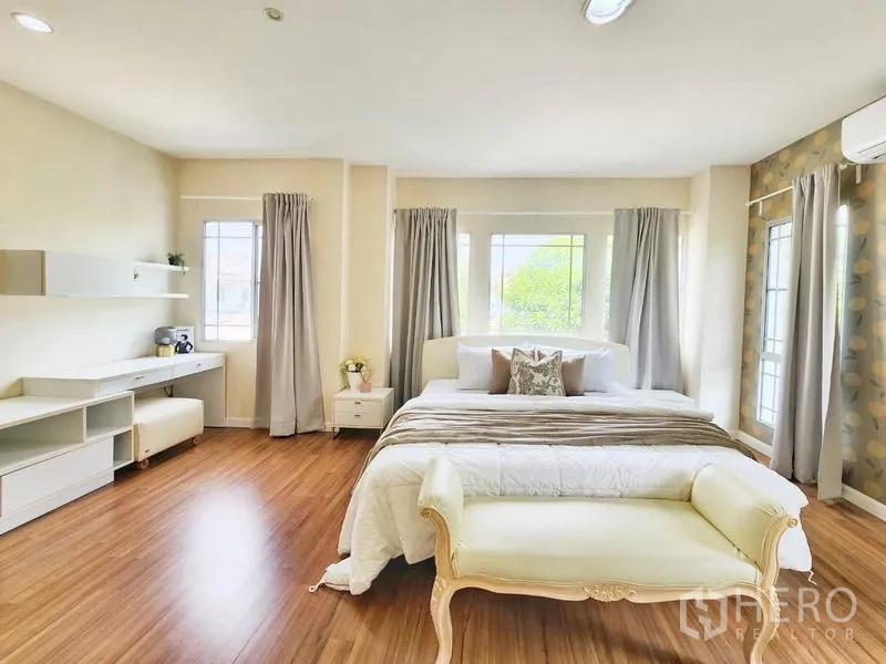 Detached House for rent in Prawet, Bangkok - Spacious master bedroom with king bed, bench, desk and wraparound windows.