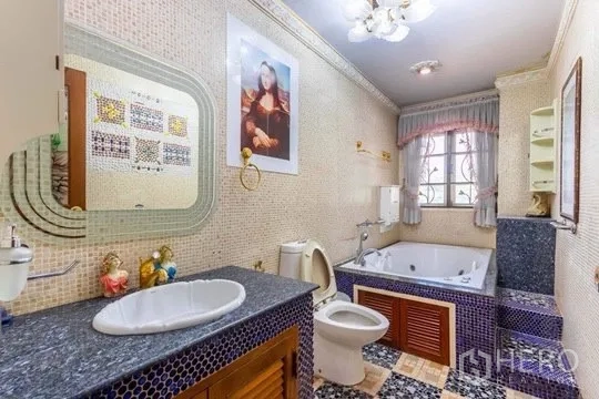 Detached House for rent or sale in Bang Khen, Bangkok - Bathroom with mosaic tiles, granite counter, jacuzzi bathtub, and window.