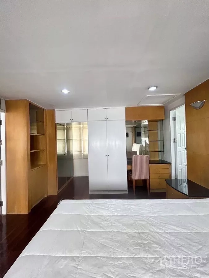 Detached House for rent in Suan Luang, Bangkok - Master bedroom view showing closets and a study desk.