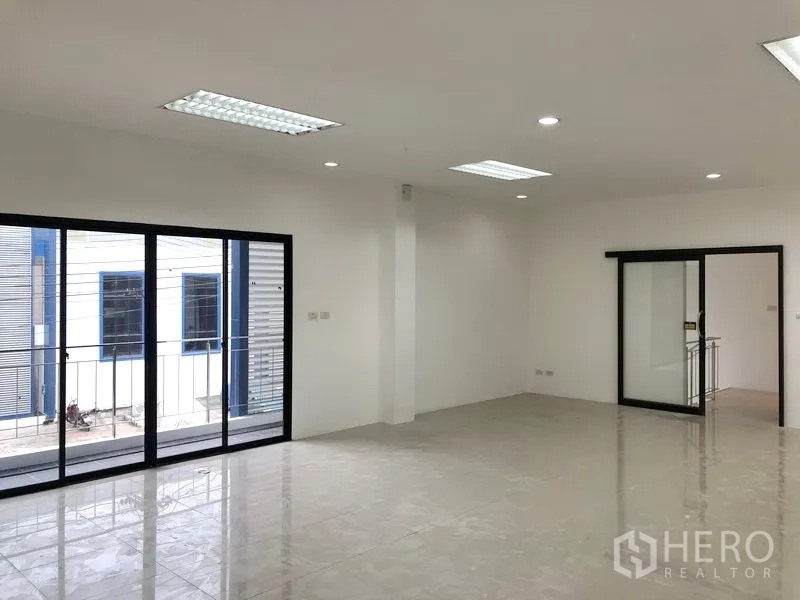 Factory for rent or sale in Samut Prakan - Second-floor open-plan office with balcony railing and ample natural light.
