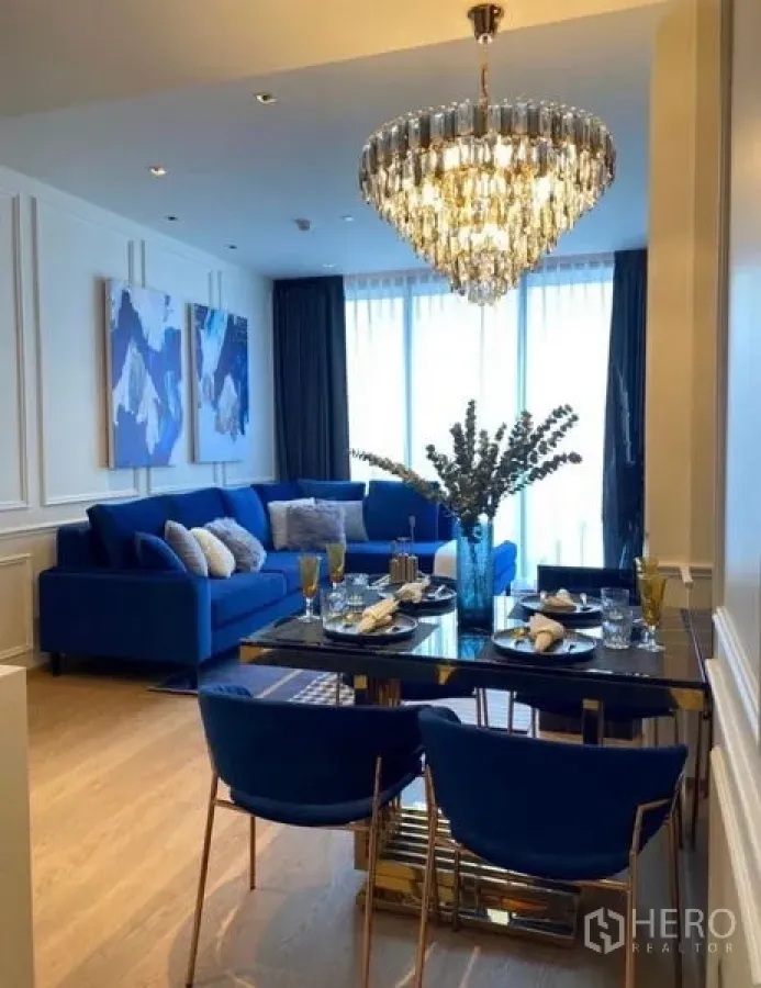 Condominium for rent - Open‑plan dining and lounge with blue accents and full‑height windows, ideal for entertaining.