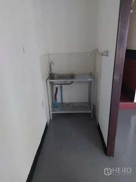 Office Space for rent in Pathum Wan, Bangkok - Compact pantry with a stainless-steel sink and storage shelf beside the restroom.