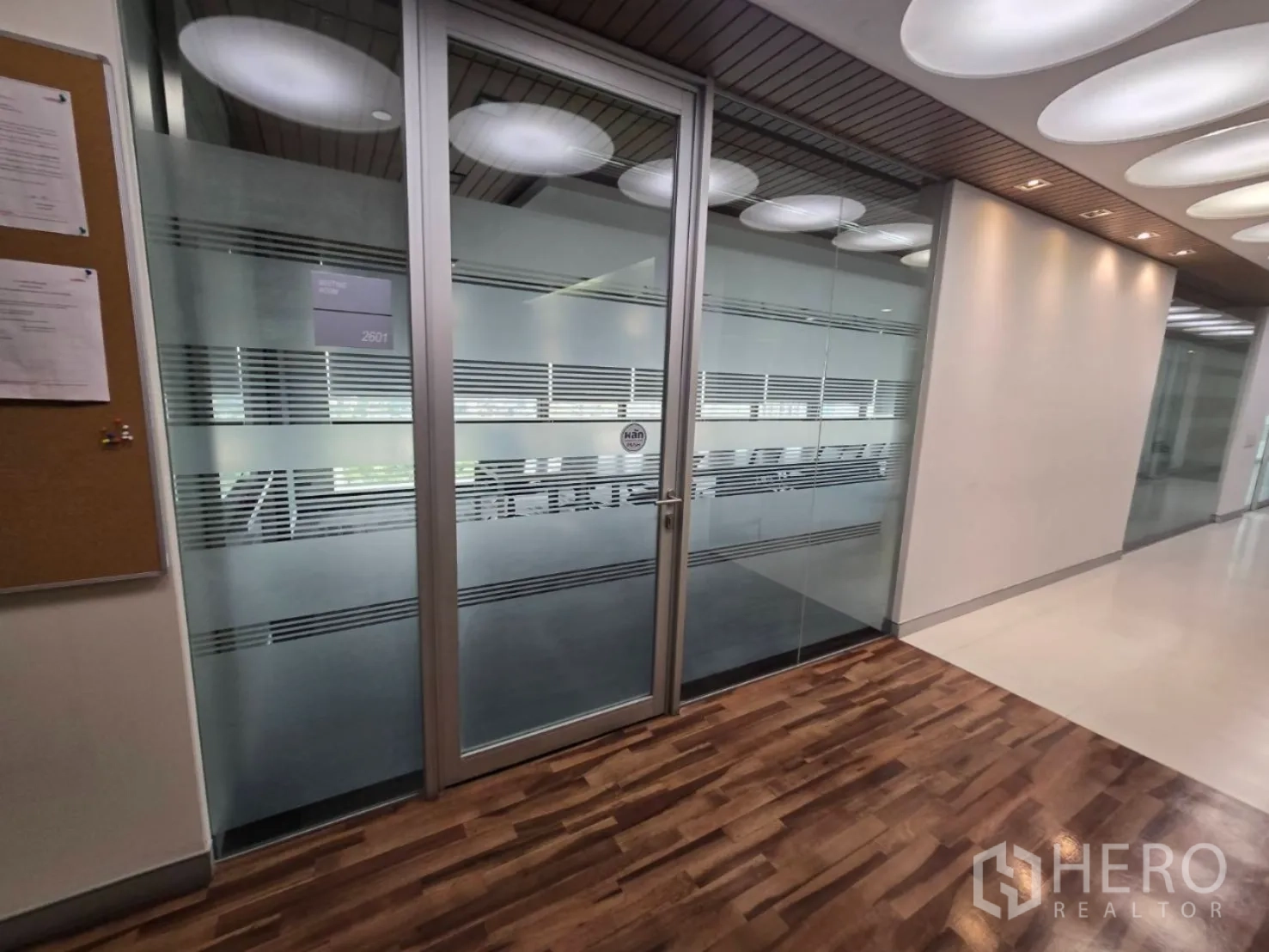 Office Space for rent in Watthana, Bangkok - Frosted glass meeting room door along wood corridor in a fitted office.