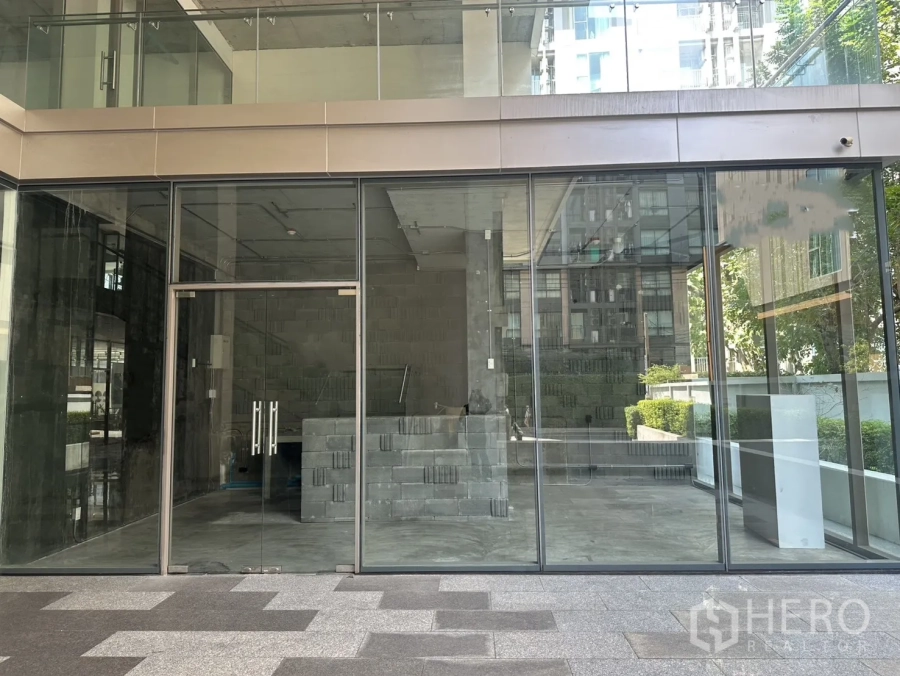 Retail Space for rent in Phra Khanong, Bangkok - Exterior view of the retail unit with full-height glass facade and double doors at ground level.