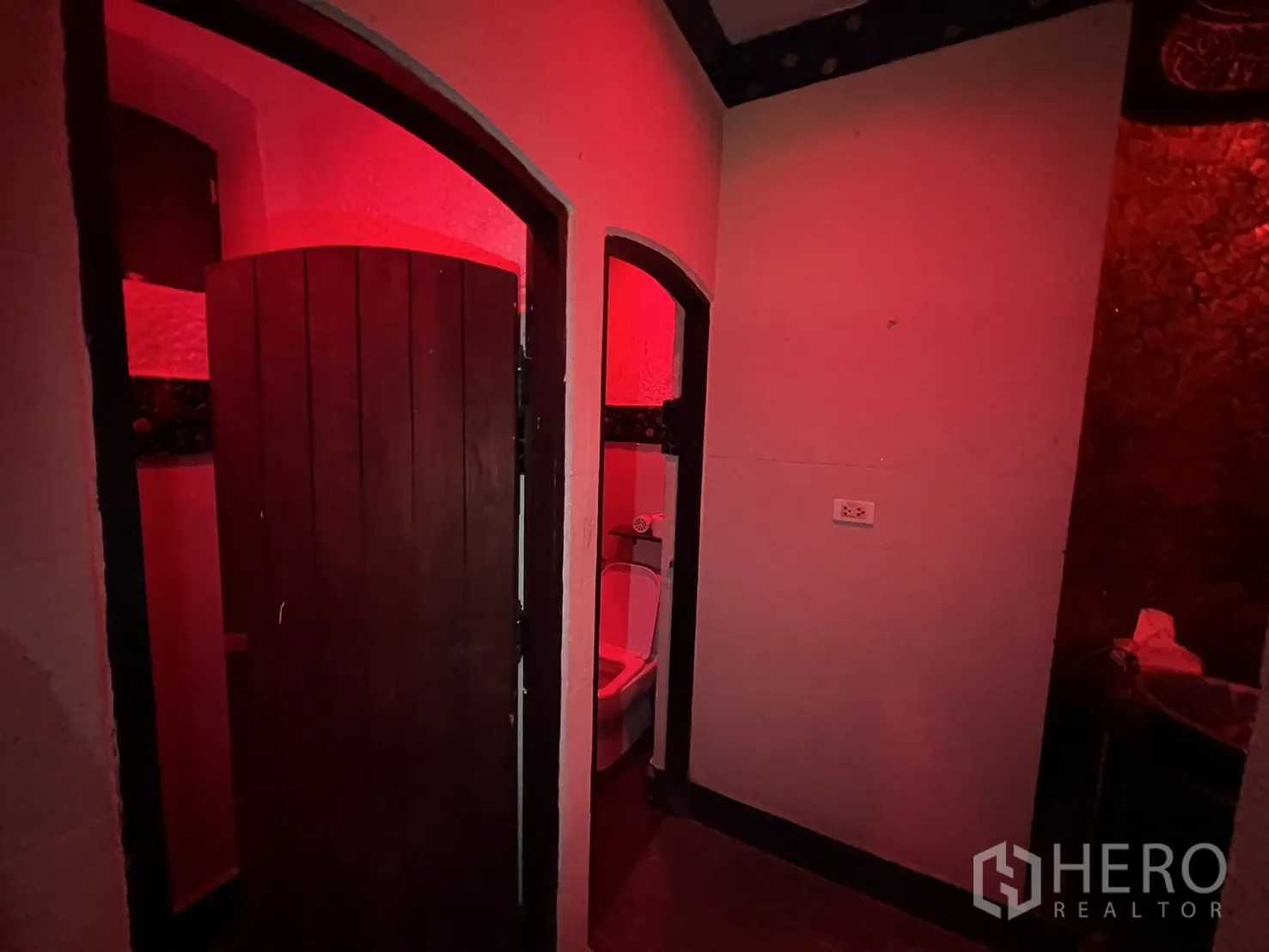 Retail Space for rent in Watthana, Bangkok - Restroom zone with arched doors and warm red accent lighting.