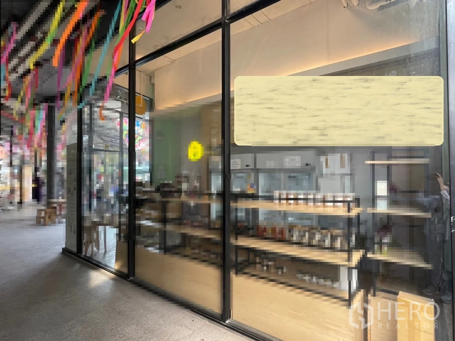 Retail Space for rent in Khlong Toei, Bangkok - Modern shopfront with large display windows and interior shelving along a lifestyle mall walkway.