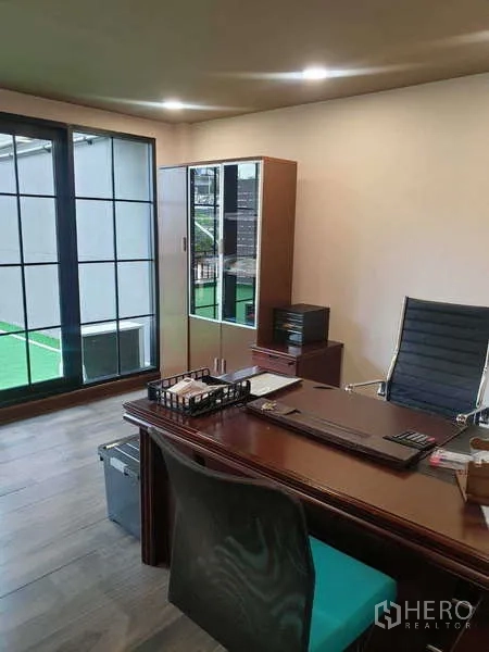 Home Office for rent in Khlong Toei, Bangkok - Private executive workspace with cabinets and floor-to-ceiling windows.
