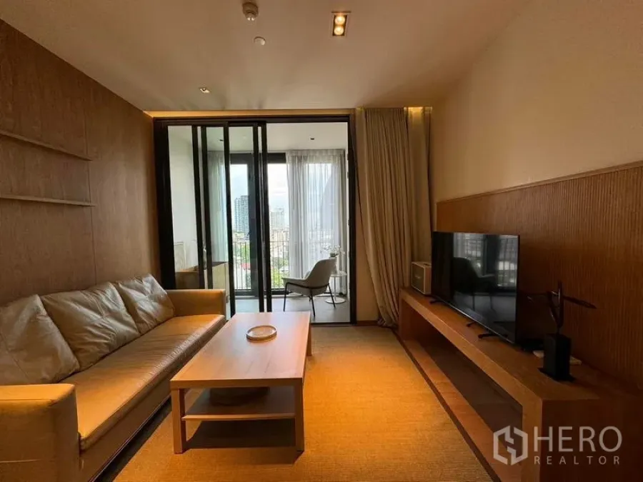 Condominium for rent in Khlong Toei, Bangkok - Living room facing balcony and city skyline beyond at Thonglor-area condo.