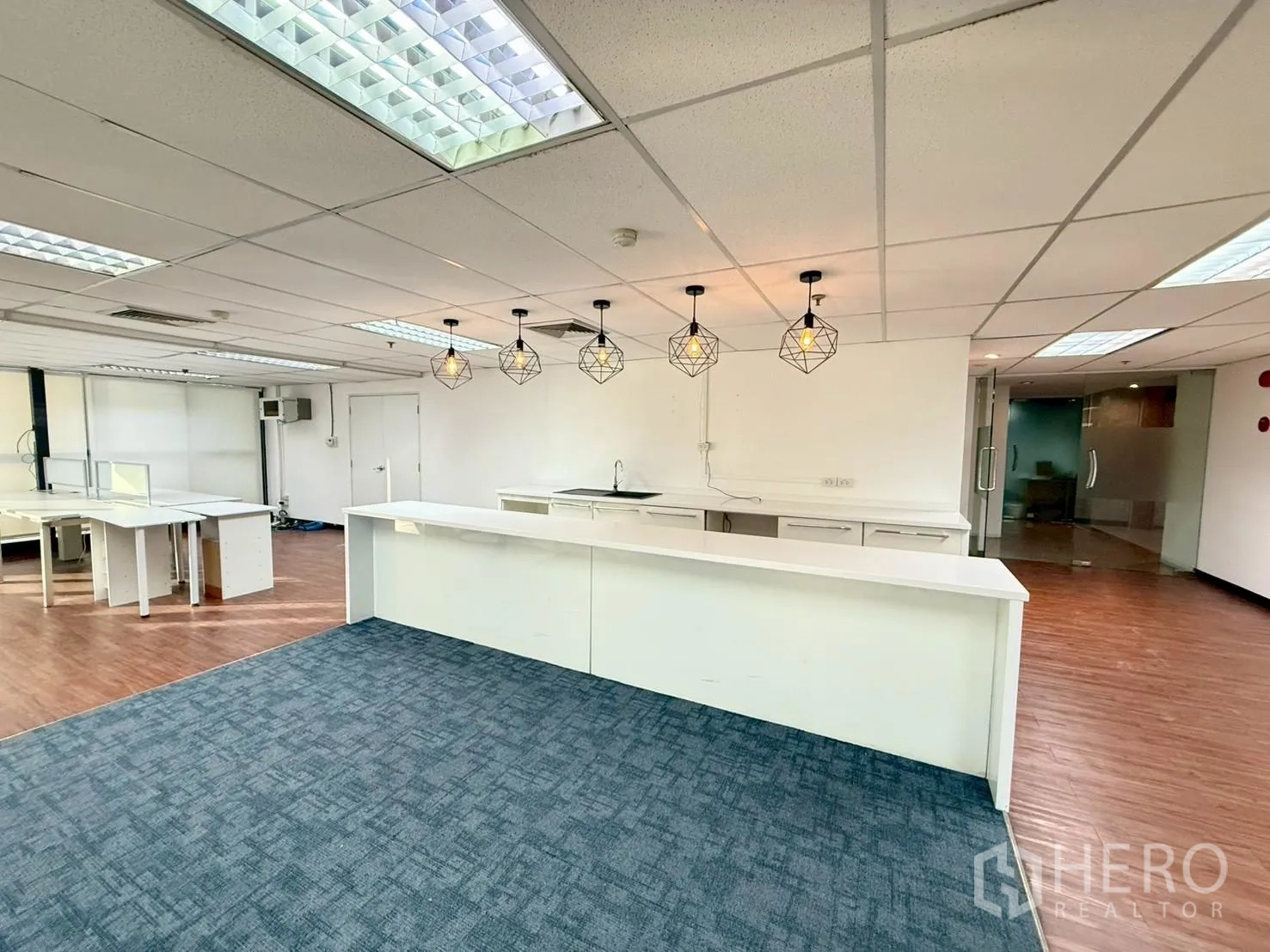 Office Space for rent in Watthana, Bangkok - Reception-style counter and pantry with geometric pendant lighting and carpeted zone.