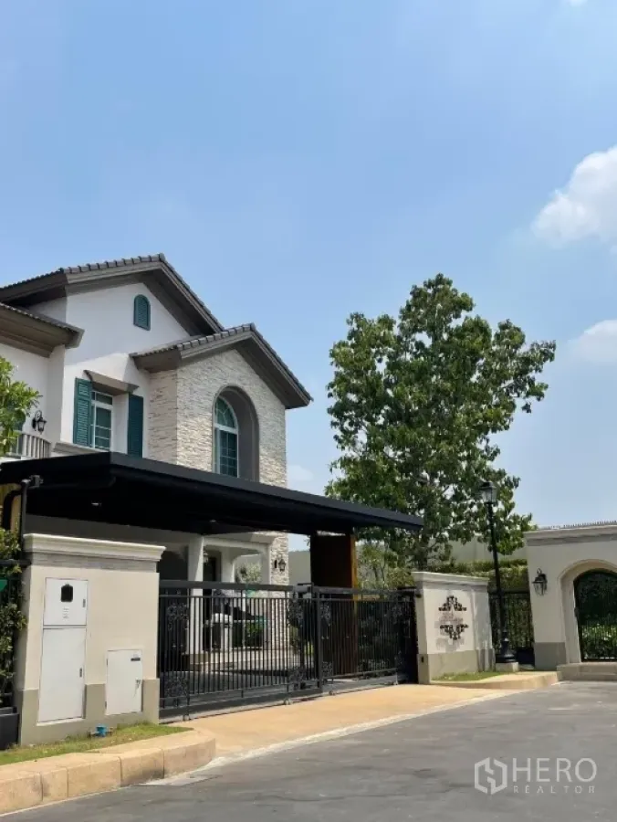 Detached House for rent or sale in Bang Khen, Bangkok - Corner detached house exterior with gated entrance and stone façade.