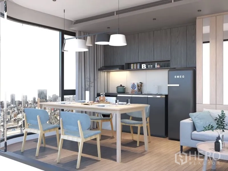 Condominium for rent or sale in Bang Rak, Bangkok - Open-plan kitchen and dining with SMEG fridge, light wood cabinetry, pendant lights and floor-to-ceiling windows facing the city skyline.