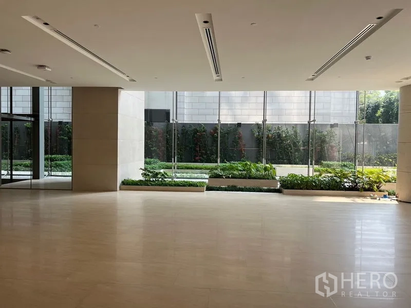Retail Space for rent - Ground-floor showroom-style space with wide floor area, full-height glass panels and landscaped garden views.