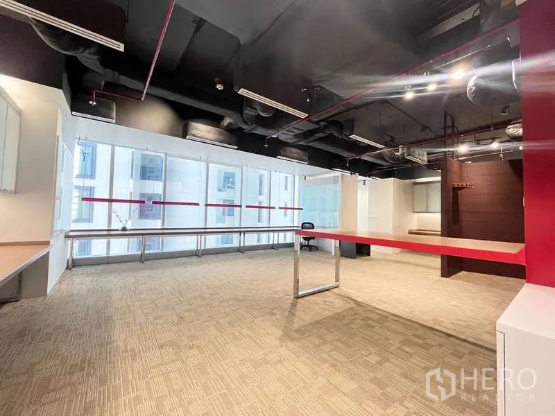 Office Space for rent in Watthana, Bangkok - Bright open area with red central bench table and full-height windows.