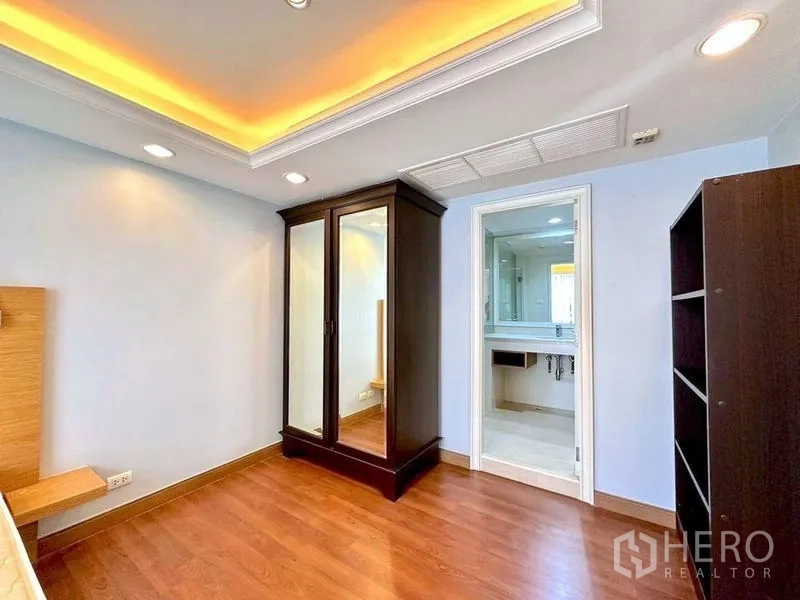 Condominium for rent - Second bedroom or dressing area with mirrored wardrobe and en-suite bathroom access.