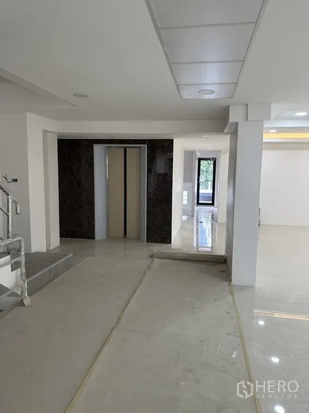 Office Space for rent or sale in Huai Khwang, Bangkok - Elevator lobby with marble surround next to a bright open-plan area.