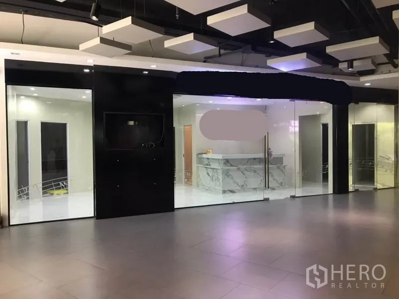 Retail Space for rent in Watthana, Bangkok - Glass-fronted shop entrance within a corridor, showcasing a marble reception inside.