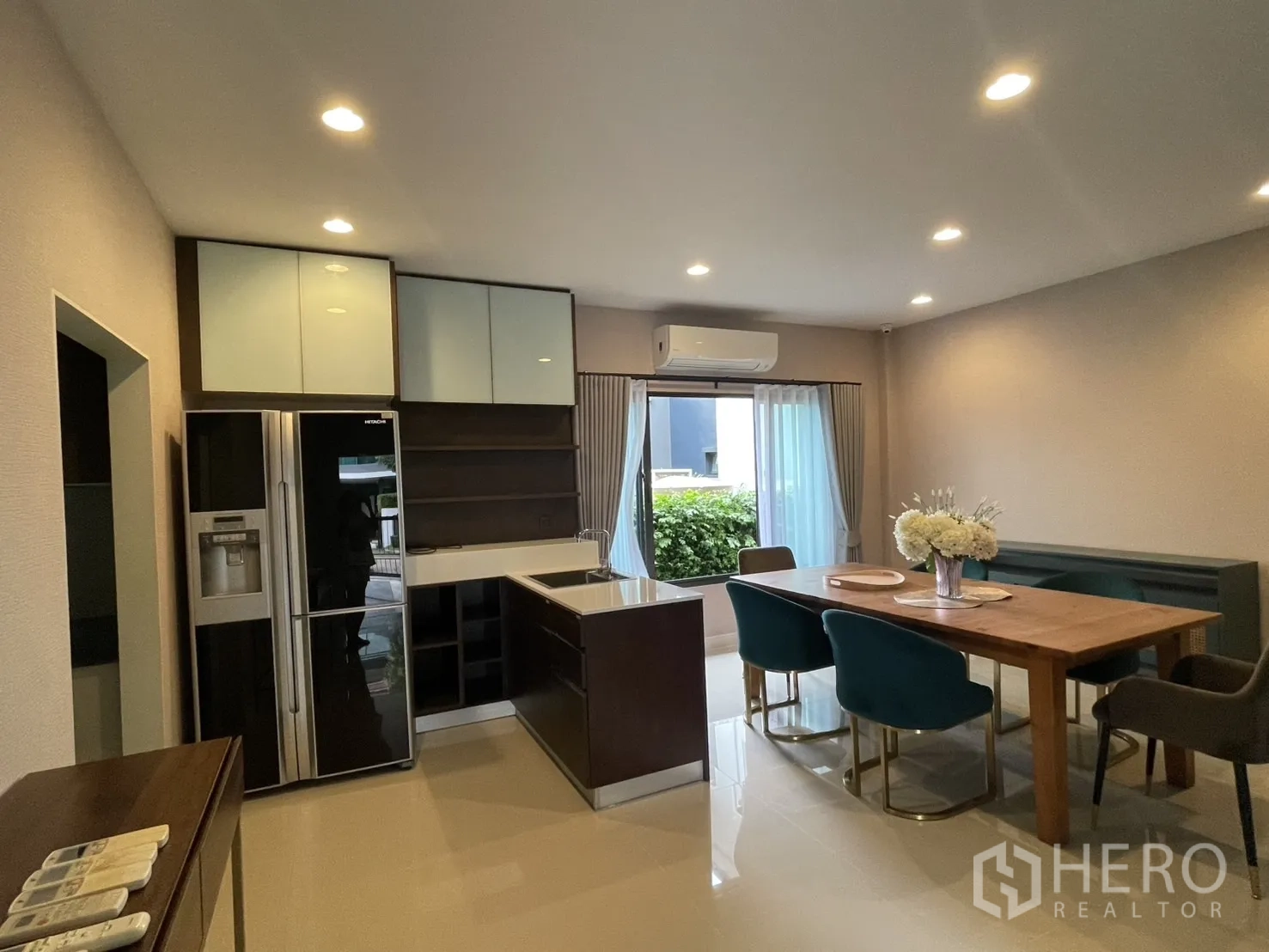 Detached House for rent in Bang Kapi, Bangkok - Open-plan kitchen and dining with large fridge and garden view.