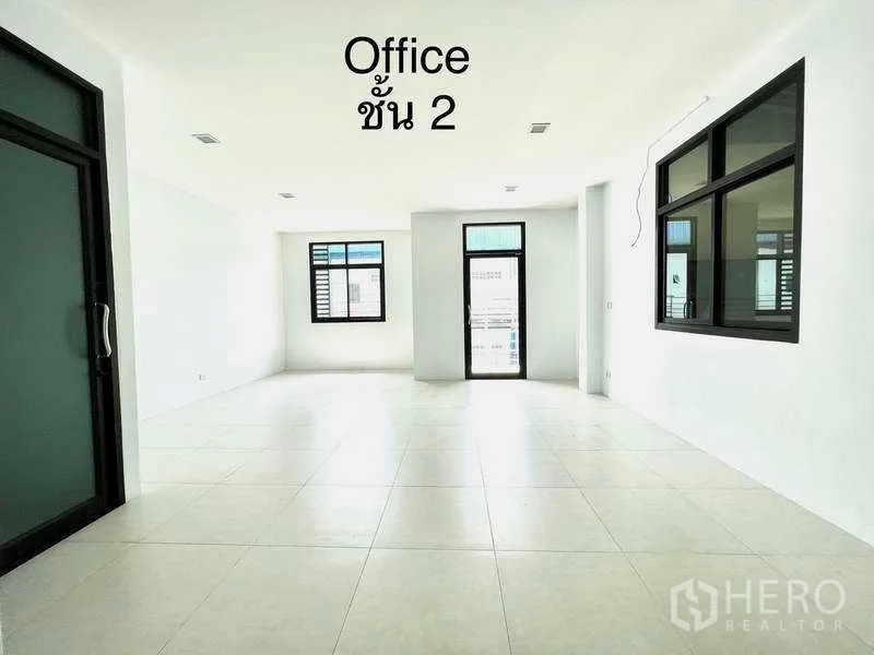 Factory for rent or sale in Mueang Samut Sakhon, Samut Sakhon - Second-floor open-plan office with large windows and a balcony door.
