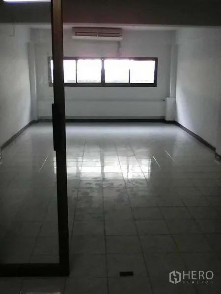 Home Office for rent or sale in Bang Na, Bangkok - Air-conditioned office room with tiled floor and a glass door.