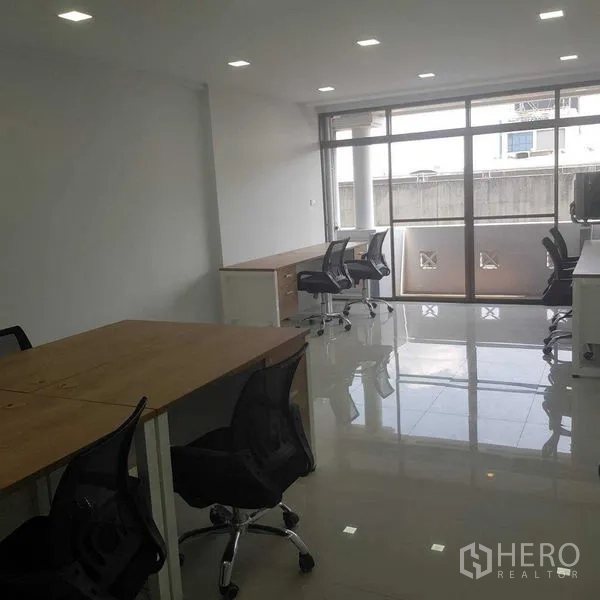 Home Office for rent or sale in Suan Luang, Bangkok - Open-plan office with desks, mesh chairs and a large window to a balcony.