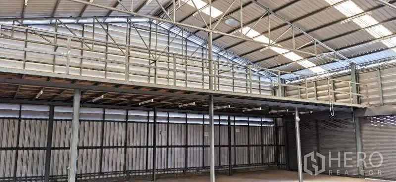 Warehouse for rent in Huai Khwang, Bangkok - Full-width interior with multiple roller shutters, bright roof lighting, and high ceiling.