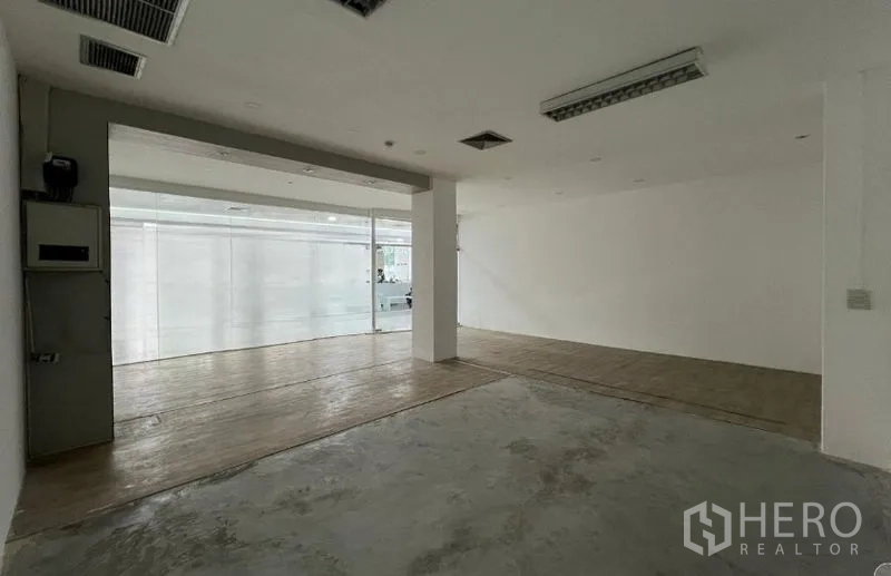 Retail Space for rent - Open-plan shop interior showing white walls, ceiling vents and a clear glass front ready for fit-out.