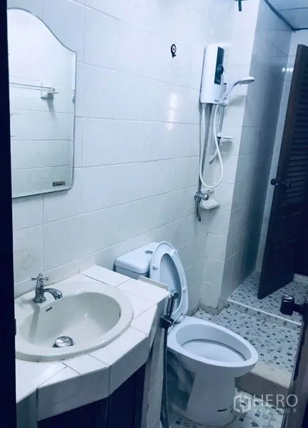 Townhouse for rent in Watthana, Bangkok - Bathroom with shower, water heater, toilet and tiled walls.
