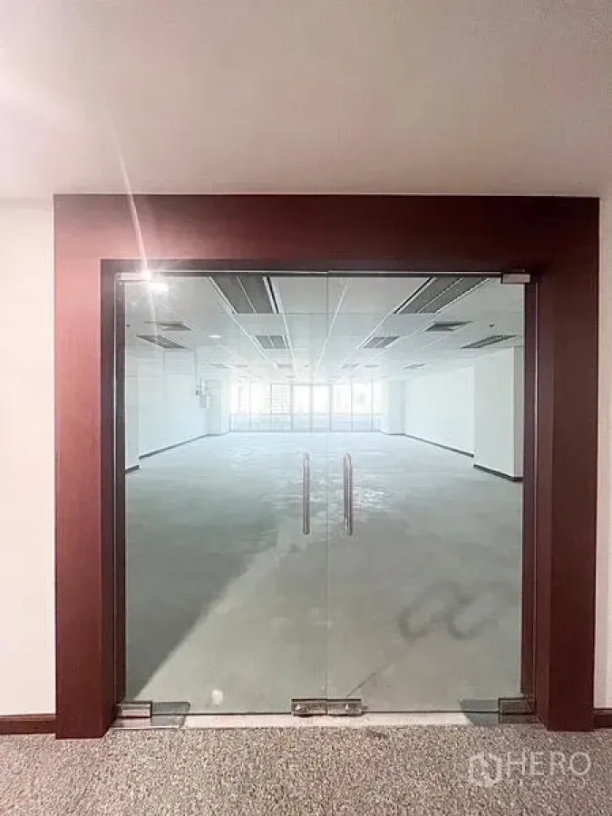 Office Space for rent in Watthana, Bangkok - Wood-framed double glass doors opening into a bright modern office space.