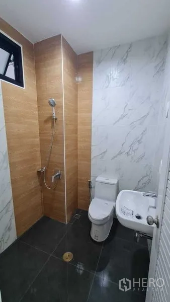 Warehouse for rent in Bang Bua Thong, Nonthaburi - Modern restroom with shower, toilet, handheld bidet, and tiled walls.