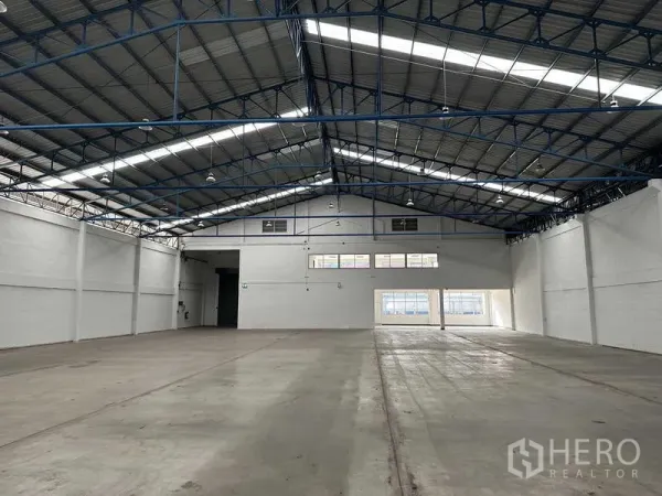 Factory for rent in Bang Phli, Samut Prakan - Spacious warehouse floor with high 8m ceiling, steel roof trusses and skylights for natural light.