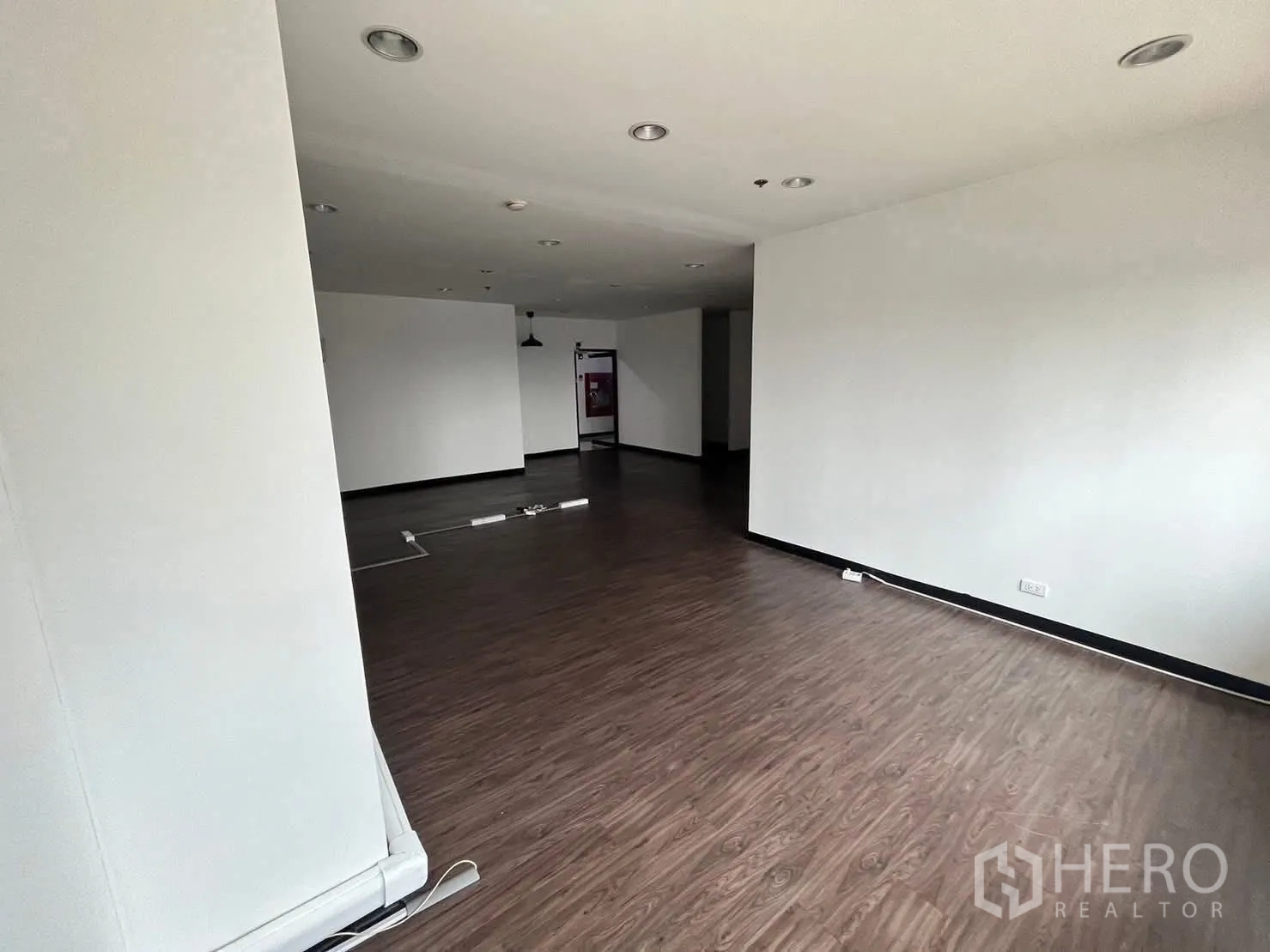 Office Space for rent in Watthana, Bangkok - View across the main office toward the entrance with surface cable trunking.
