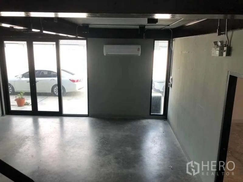 Warehouse for rent in Bang Phli, Samut Prakan - Ground-floor office area with glass doors, air-conditioning and view to parking.