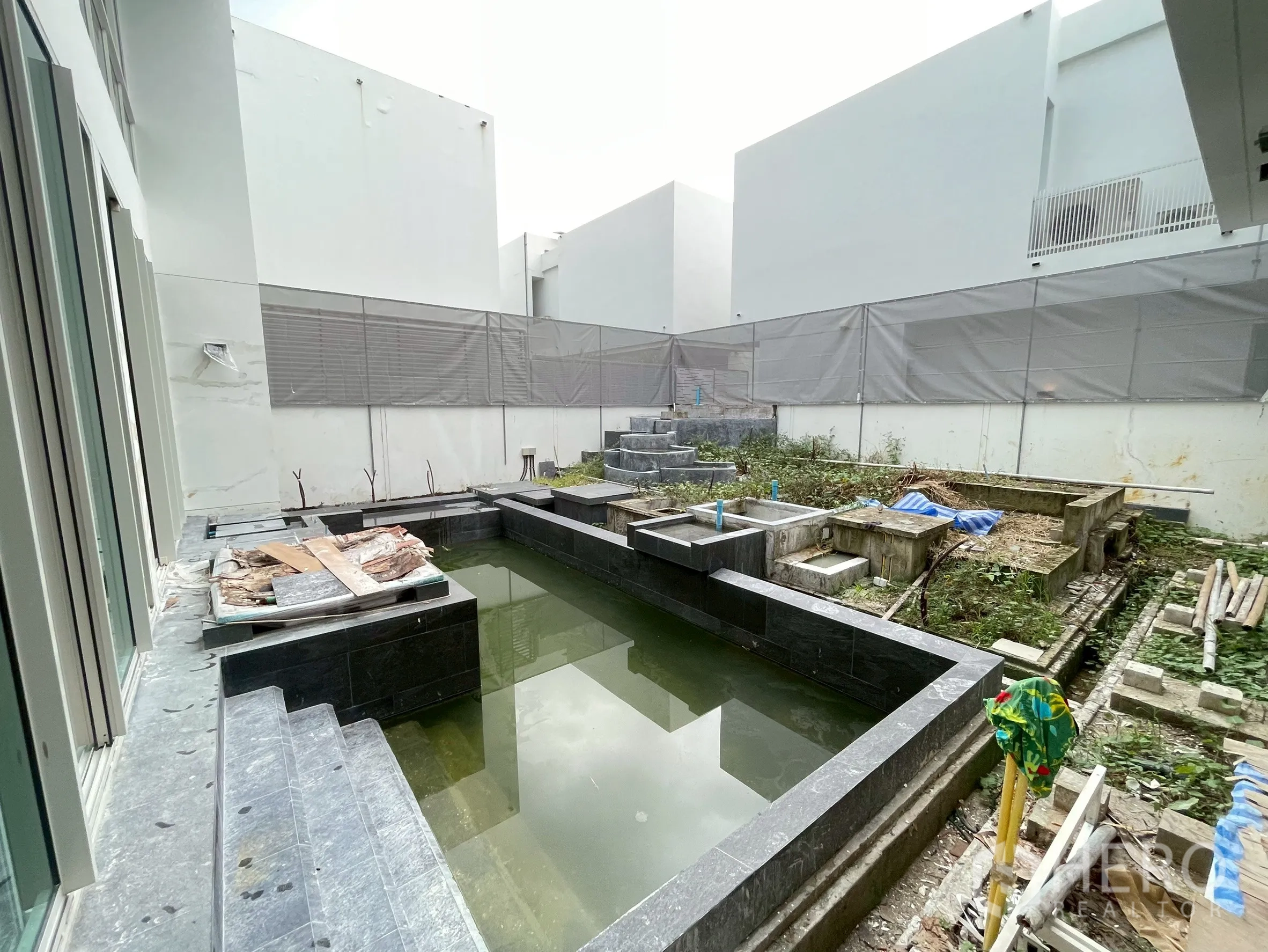 Detached House for sale in Bang Phli, Samut Prakan - Courtyard water feature or pool base under construction with stone cladding.