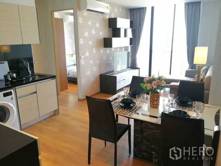 Condominium for rent - Another angle of the open-plan kitchen, dining table and sunlit living space.