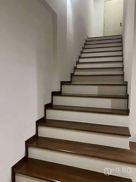 Home Office for rent in Bang Khen, Bangkok - Wide internal staircase with wooden treads leading to the upper levels of the home office.