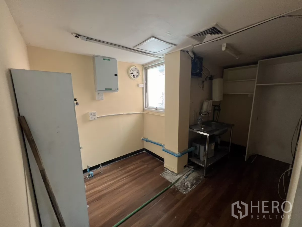 Retail Space for rent - Utility space with stainless sink, pipes and window ventilation.