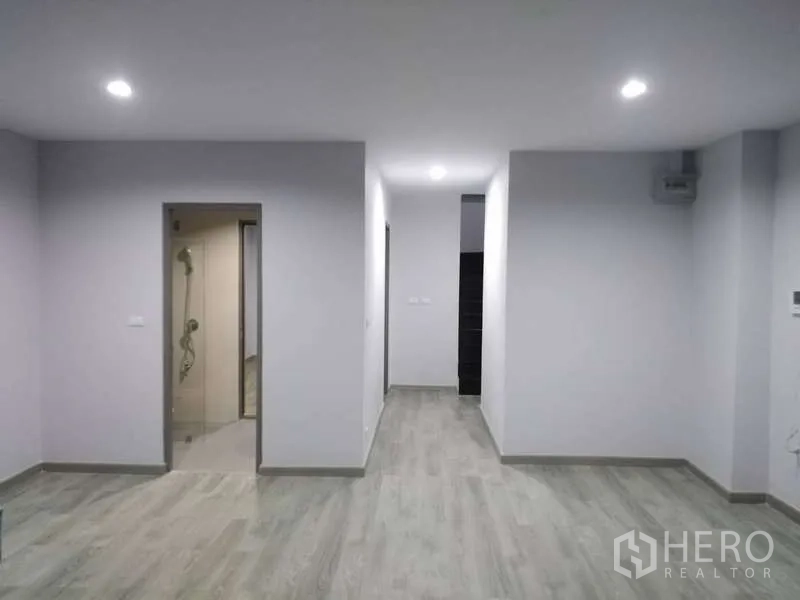 Home Office for rent or sale - Bright room with light wood floors, recessed lights and doorway to a bathroom with shower.