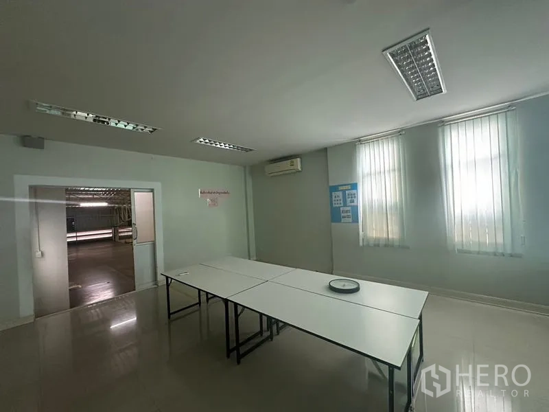 Warehouse for rent or sale in Lam Luk Ka, Pathum Thani - Meeting or training room with tables, air‑conditioning and vertical blinds.