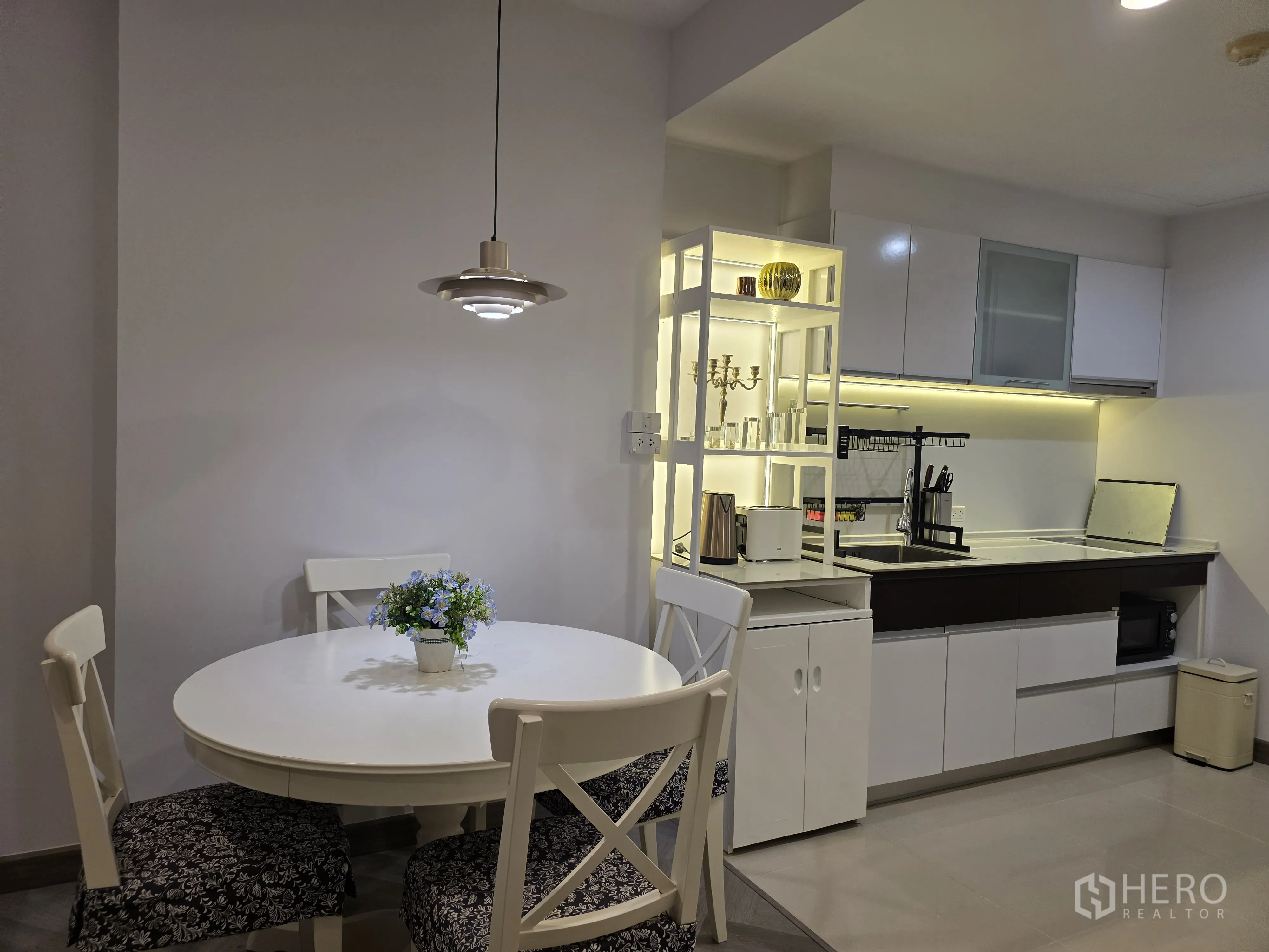 Condominium for rent in Bang Kapi, Bangkok - View from living area toward kitchen and dining with herringbone flooring.