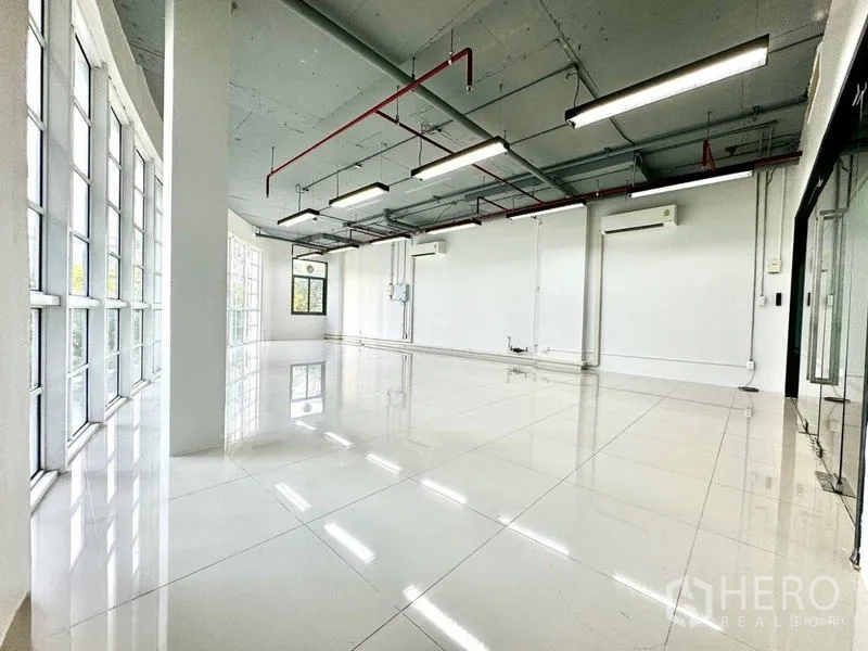 Office Space for rent in Khlong Toei, Bangkok - Open workspace with exposed ceiling, LED strip lights, and split air conditioners