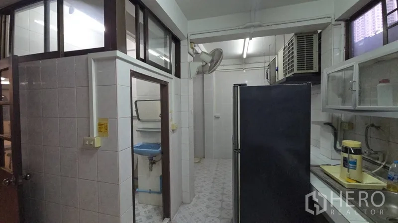 Home Office for rent in Sathon, Bangkok - Utility area beside the kitchen with tiled walls and access to storage rooms.