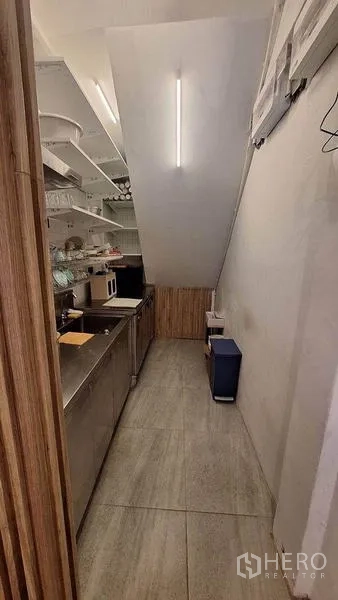 Retail Space for rent in Watthana, Bangkok - Compact back-of-house pantry with stainless counters, open shelving and task lighting.