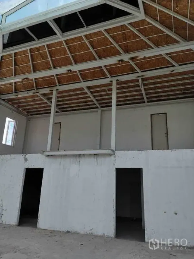 Retail Space for rent in Watthana, Bangkok - High-ceiling hall with mezzanine structure and multiple doorways for flexible layouts.